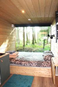 a bed in the inside of a tree house at PRIVAATNE Metsamajake SAUNAGA "VULIN" in Sigula
