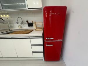 an old red refrigerator in a kitchen at Lagom villiage in Paegun-dong