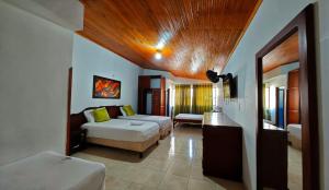 a living room with two beds and a couch at Hotel El Principe in Ocaña