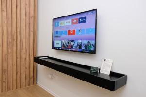 a flat screen tv hanging on a wall at Centralin Apartotel in Tirana