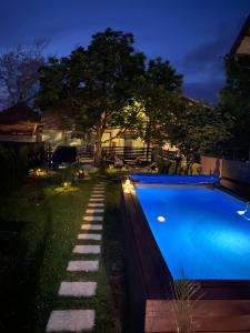 a swimming pool in a yard at night at Elephant House-Sd in Seone