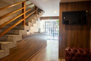 a living room with a staircase and a television at Gran Vila Nai Boutique Hotel in Guadalajara +56 photos