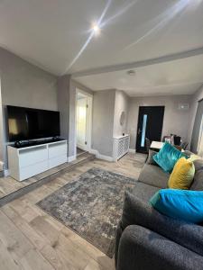 a living room with a couch and a flat screen tv at Sea breeze house in Dog Island