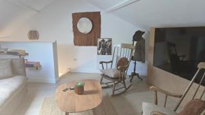 a living room with a couch and a table at Casa del Castel in Dreux