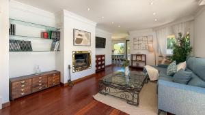 a living room with a couch and a table at Villa Terramar by Hello Homes Sitges in Sitges