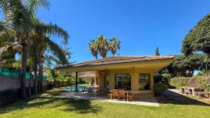 a house with a patio with tables and chairs at Villa Terramar by Hello Homes Sitges in Sitges