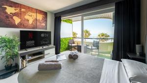a bedroom with a bed with a view of the ocean at Marbella Beachfront Studio with Stunning Sea Views in Marbella