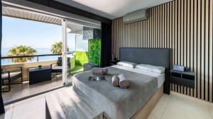 a bedroom with a bed with a view of the ocean at Marbella Beachfront Studio with Stunning Sea Views in Marbella