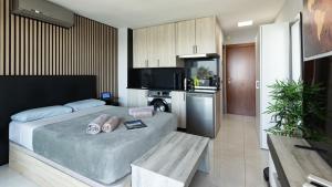 a bedroom with a large bed and a kitchen at Marbella Beachfront Studio with Stunning Sea Views in Marbella +28 photos