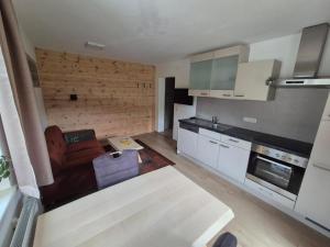 a kitchen with a couch and a table in a room at Urlauben im Grünen in Fuschl am See