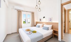 a bedroom with a bed and a window at Georgioupolis Blue Villa in Georgioupolis