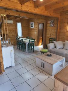 a living room with a couch and a table at Loue chalet in Bias