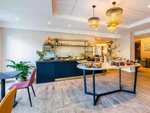 a kitchen with a table with food on it at ibis Styles Rennes Cesson in Cesson-Sévigné