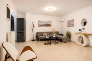 a living room with a couch and a table at AVENTINE - Luxury Residences with Private Pools in Kalithies