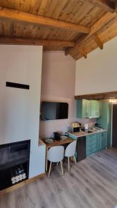 a kitchen with a table and chairs in a room at Stone Loft in Karpenisi