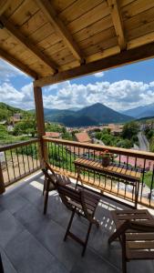 a table and chairs on a balcony with a view at Stone Loft in Karpenisi