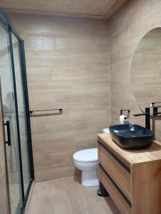 a bathroom with a sink and a toilet at Cabaña Cala Blanca II in Málaga +10 photos