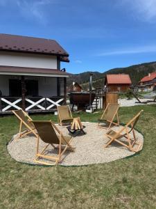 a group of lawn chairs sitting on a rug at Лайт Хайс Буковель in Palyanytsya