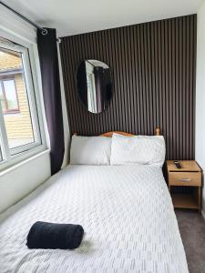 a bedroom with a bed and a mirror on the wall at 52 strawberry in Hayle