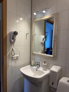 a bathroom with a sink and a mirror and a toilet at Hótel Húsavík in Húsavík +97 photos