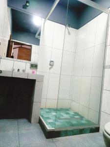 a shower with a glass door in a bathroom at B&B Recoleta in Sucre +7 photos