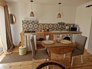 a kitchen with a wooden table with chairs and a stove at Casa Brens in Brens