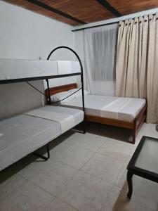 a room with two bunk beds and a table at Finca la santa in San Luis de Cubarral +14 photos