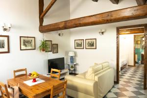 a living room with a wooden table and a couch at La casa di Mariasole in SantʼElpidio a Mare