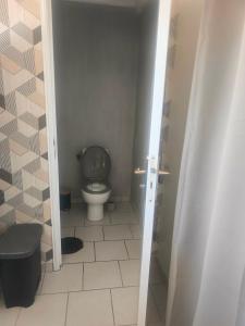 a small bathroom with a toilet in a room at Emplacement de tente in Hardinghen +1 photo