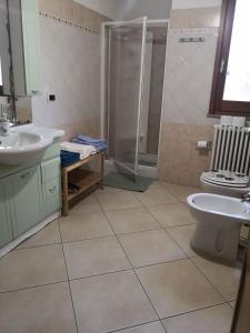 a bathroom with a shower and a toilet and a sink at Domo Mea in Orgosolo +11 photos
