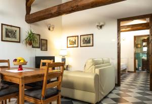 a living room with a table and a couch at La casa di Mariasole in SantʼElpidio a Mare