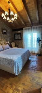 a bedroom with a bed and a wooden ceiling at Pensión Los Pasiegos in Reocín