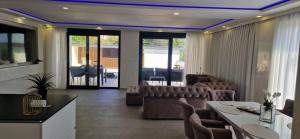 a living room with a couch and a table and chairs at Villa Maja in Sutomore