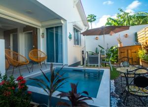 a house with a swimming pool and a patio at Villa piscine privée Grand-Bourg proche plage in Grand-Bourg