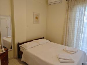 a bedroom with a bed with two towels on it at Mary's Home in Kalamata