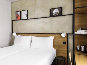 a bedroom with a white bed and a wall at ibis Bridgwater, M5 Jct23 in Bridgwater +57 photos