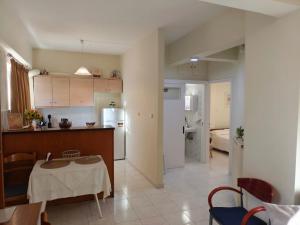 a kitchen and living room with a table and a kitchen and a room at Mary's Home in Kalamata