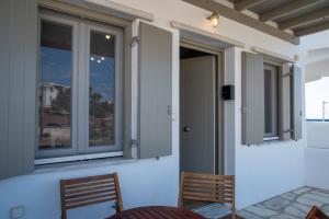 a room with two chairs and a window at Easy Living Tinos in Vrachonisída Chántra +31 photos