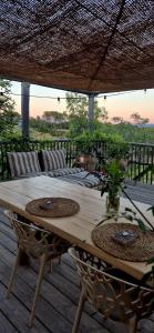 a wooden table with chairs on a wooden deck at Casa Utopia in Miravet