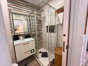 a bathroom with a glass shower and a sink at Timeless Beach V - Apartment in Armação de Pêra +30 photos