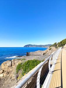 a boardwalk over the ocean on a beach at Uliveto in Diano San Pietro