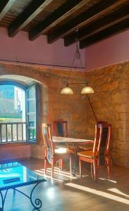 a dining room with a wooden table and chairs at El Rincon de Belen in Noriega