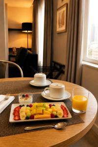 a tray of fruit on a table in a hotel room at Hotel Sommelier Agustinas in Santiago