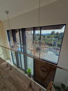 a large window in a building with a chandelier at Hotel LUHA in Puerto Varas