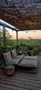 a bed sitting on top of a wooden deck at Casa Utopia in Miravet +15 photos