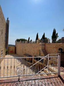 a metal railing in front of a brick wall at جبال جرش in Jerash