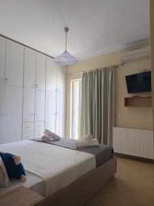 a bedroom with a large bed and a window at The View in Souvala