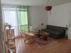 a living room with a couch and a table at Olembe Garden in Avon