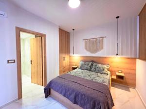 a bedroom with a large bed and a mirror at Anthouli Homes 2, steps from beach and centre in Kardamaina