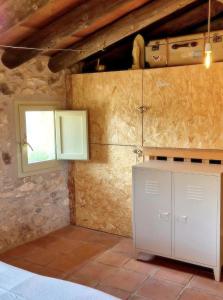 a kitchen with a white cabinet and a window at Casa Utopia in Miravet